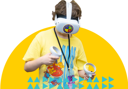 A young boy playing with a virtual reality headset in the YouMedia lab.
